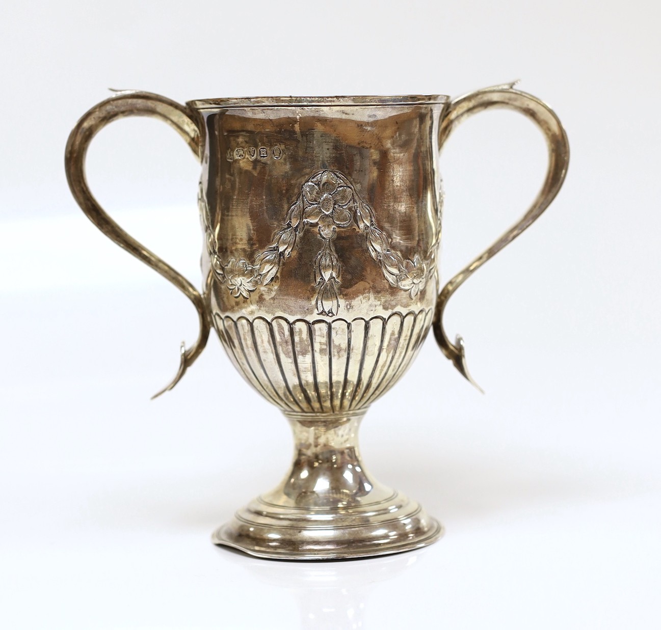 A George III silver two-handled cup, with later embossed decoration, Peter, Ann & William Bateman, London, 1803, height 15.1cm, 9.5oz.